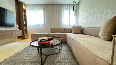 a living room with a couch and a table at Street view 2BR Terrace - AppartAli Luxury Platform in Casablanca