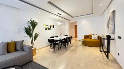 a living room with a couch and a table and chairs at Street view 2BR Terrace - AppartAli Luxury Platform in Casablanca