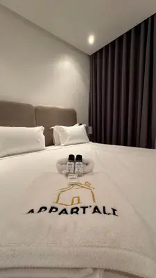 a hotel room with a white bed with the words apartheid at Street view 2BR Terrace - AppartAli Luxury Platform in Casablanca