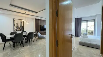 a dining room and living room with a table and a bedroom at Dreamy 3BR with Terrace -AppartAli Luxury Platform in Casablanca
