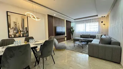 a living room with a dining table and a couch at Dreamy 3BR with Terrace -AppartAli Luxury Platform in Casablanca