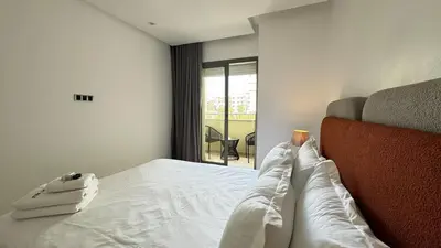a bedroom with a bed with white sheets and a window at Dreamy 3BR with Terrace -AppartAli Luxury Platform in Casablanca
