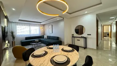 a living room with a table and a couch at 7th Floor 3BR with Terrace - AppartAli Luxury Platform in Casablanca