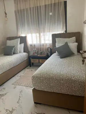 a bedroom with a bed and a window at Cosy appartement lumineux Awards 2026 in Bouznika
