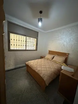 a bedroom with a bed and a window at Villa à Harhoura in Temara