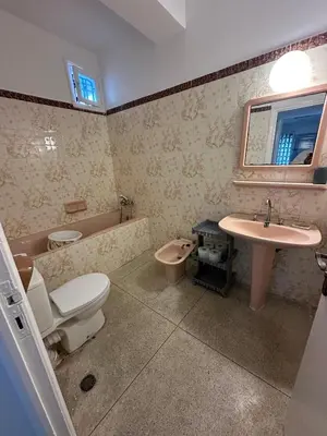 a bathroom with a toilet and a sink and a tub at Villa à Harhoura in Temara