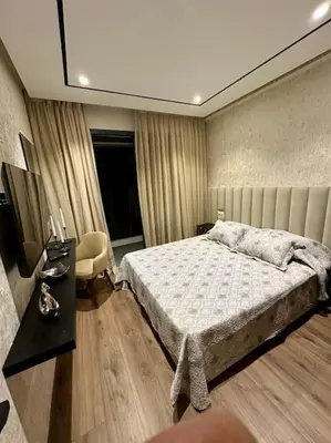 a bedroom with a bed and a desk and a bed sidx sidx sidx at Studio Lilas CFC in Casablanca