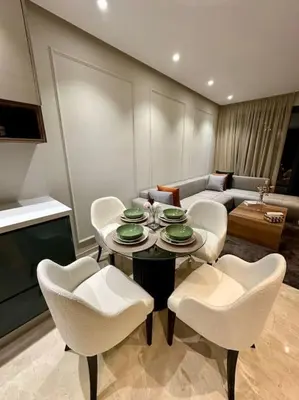 a living room with a table and chairs and a couch at Studio Lilas CFC in Casablanca