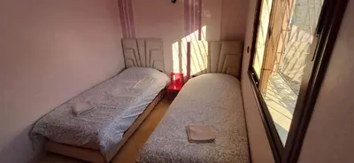 two beds in a small room with a window at Appartement très propre et calme in Bouznika