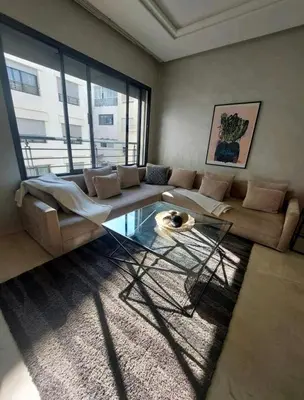 a living room with a couch and a glass table at Downtown apartment in Casablanca