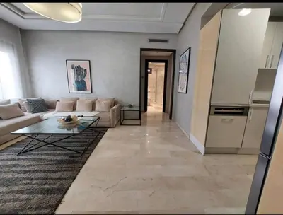 a living room with a couch and a table at Downtown apartment in Casablanca