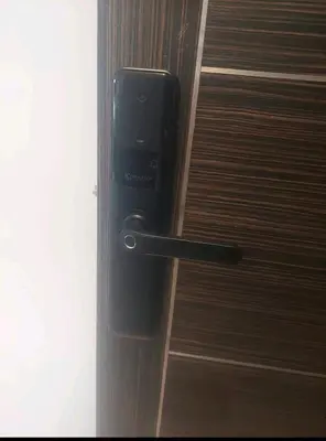 a cell phone on a door handle on a wooden door at Downtown apartment in Casablanca