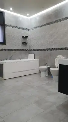 a bathroom with a tub and a toilet and a sink at Villa entière in Azemmour