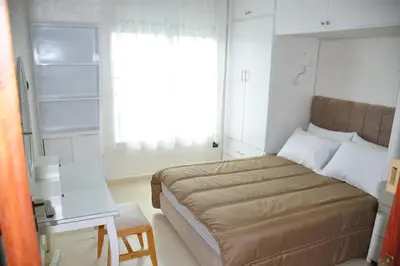 a small bedroom with a bed and a window at Appartement a louer Harhoura in Temara