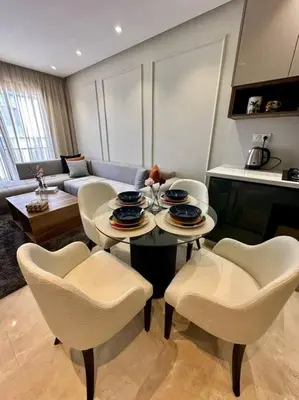 a living room with a table and chairs at Studio Eucalyptus CFC n 16 in Casablanca