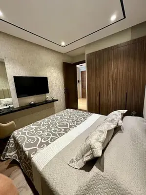 a bedroom with a bed and a flat screen tv at Studio Eucalyptus CFC n 16 in Casablanca