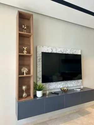 a entertainment center with a large television on a wall at Studio Jasmin CFC n 15 in Casablanca