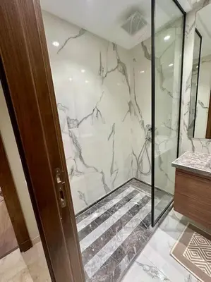 a bathroom with a shower and a glass door at Studio Jasmin CFC n 15 in Casablanca