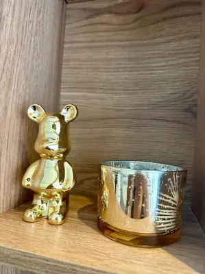 a gold bear figurine next to a cup on a shelf at Studio lotus CFC n 21 in Casablanca