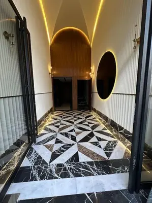 a hallway with a black and white tiled floor at Studio lotus CFC n 21 in Casablanca