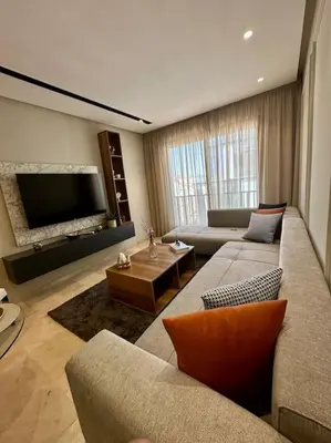 a living room with two couches and a flat screen tv at Studio lotus CFC n 21 in Casablanca