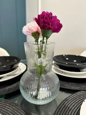 a glass vase with flowers in it on a table at Studio Vénus CFC n 22 in Casablanca