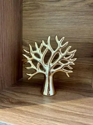 a metal tree ornament on a wooden wall at Studio Vénus CFC n 22 in Casablanca
