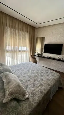 a bedroom with a bed and a flat screen tv at Studio Vénus CFC n 22 in Casablanca