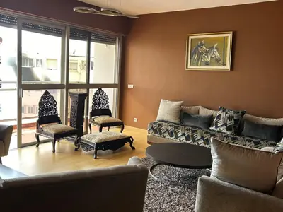 a living room with a couch and chairs at Magnifique appartement maarif in Casablanca