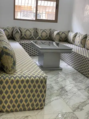 a living room with a couch and a table at Bel appartement de plage - RDC - Dahomey Beach in Bouznika