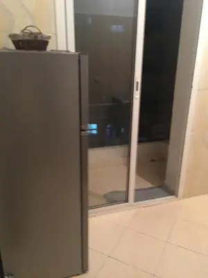 a glass door of a refrigerator in a room at Mohammed V Airport Appartement in Deroua