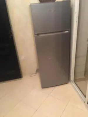 a stainless steel refrigerator in a kitchen next to a window at Mohammed V Airport Appartement in Deroua