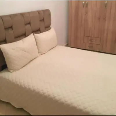 a bed with two pillows on top of it at Mohammed V Airport Appartement in Deroua