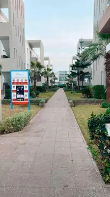 an empty sidewalk in a city with buildings at 2 bedroom appart at the beach in gated community with pool in Sidi Rahal