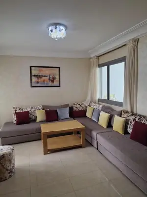 a living room with a couch and a coffee table at 2 bedroom appart at the beach in gated community with pool in Sidi Rahal