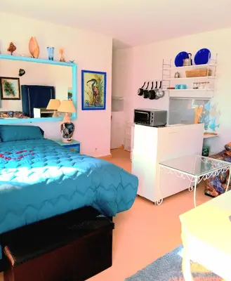a bedroom with a blue bed in a room at Skhirat terrace apartment at the beach in Skhirat