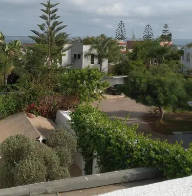 an aerial view of a house with trees and bushes at Skhirat terrace apartment at the beach in Skhirat