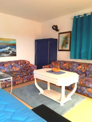 a living room with a couch and a table at Skhirat terrace apartment at the beach in Skhirat