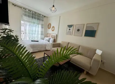 a living room with a couch and a bed at très joli appartement vue sur mer présentation acte de mariage si couple in Rabat