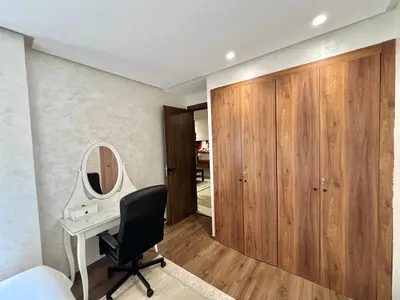 a bedroom with a desk and a chair and a mirror at Appartement chic à Bourgogne Proche mosquèe Hassan II in Casablanca