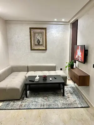 a living room with a couch and a coffee table at Appartement chic à Bourgogne Proche mosquèe Hassan II in Casablanca