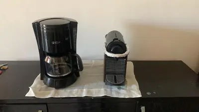 a coffee maker and a camera on a counter at Appartement en bord de mer dans une résidence fermée in Casablanca