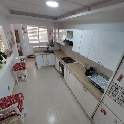 a kitchen with white cabinets and a counter top at Havre de paix à TAMARIS in Dar Mohammed Ould Haj Jilali