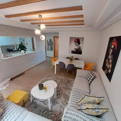 a living room with a couch and a table at Havre de paix à TAMARIS in Dar Mohammed Ould Haj Jilali