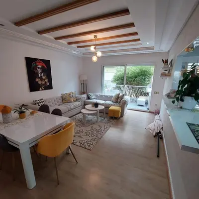 a living room with a couch and a table at Havre de paix à TAMARIS in Dar Mohammed Ould Haj Jilali