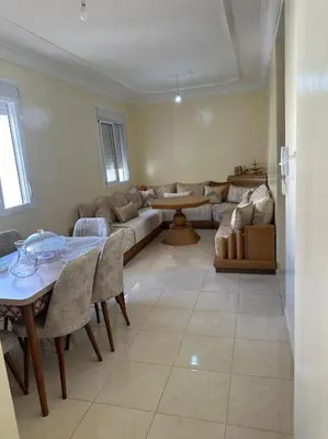 a living room with a couch and a table at Well-equipped luxury apartment in Temara