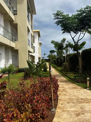 a walkway in front of a apartment building at Appartement de vacances CASABAY Sidi Rehal in Sidi Rahal