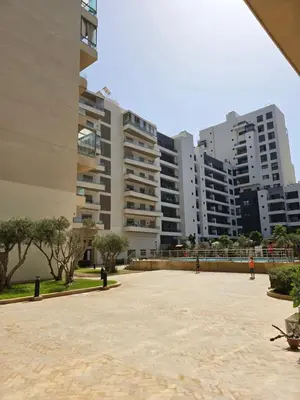 a large courtyard in a city with tall buildings at Duplex Zenata Tower in Aïn Harrouda