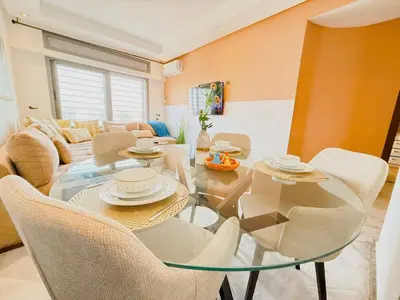 a living room with a glass table and chairs at Cosy and sunny - private Rooftop - near train & tramway in Casablanca