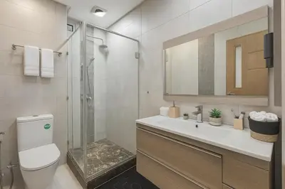 a bathroom with a shower and a toilet and a sink at Cosy and sunny - private Rooftop - near train & tramway in Casablanca